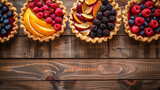 Row of diffrent summer colourful pies homemade with mix fresh berries. Healthy dessert breakfast on horizontal wooden background, top view, copy space. Bakery concept. fruit dessert. Fruit cake