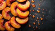   A table holds a collection of sliced peaches, their edges touching Droplets of water dot the surface beneath them, darkening it against the black background