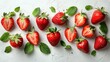   A collection of strawberries on a pristine white background, surrounded by emerald green leaves atop and beneath them