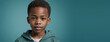 An African American Juvenile Boy, Isolated On A Teal Background With Copy Space