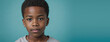 An African American Juvenile Boy, Isolated On A Turquoise Background With Copy Space