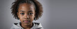 An African American Juvenile Girl, Isolated On A Silver Background With Copy Space