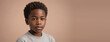 © Pixel Matrix - 10-12 Years African American Boy, Isolated On A Peach Background With Copy Space