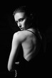 Beautiful sexy Girl in Dress with naked back. Black and white portrait