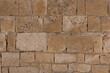Textured Sandstone Wall. Close-up of weathered sandstone blocks in wall
