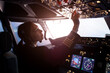 © mrkotov - A female pilot controls a large passenger plane