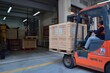 Warehouse forklift unloading wooden box