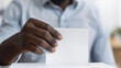 man's hand putting his ballot in the ballot box 
