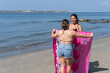 © Hector Pertuz - Friends Sharing Towel on Beach