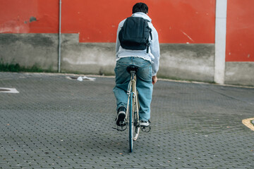 Poster - young man or student with backpack riding on vintage bicycle