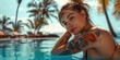 A woman with tattoos on her arm is sitting in a pool, resort, vacation