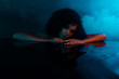 © Beauty Hero - Passionate charming lady touching water relaxing in spa center mysterious atmosphere in dark illuminated bathroom
