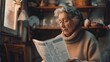 An old woman is reading a newspaper at home