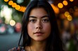 Portrait of a beautiful young woman with long black hair in the city