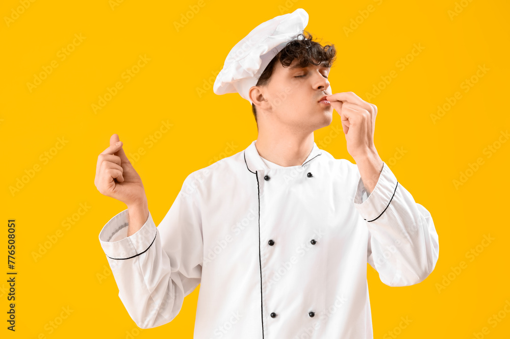 Male chef on yellow background