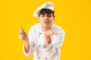 Poster - Male chef blowing kiss on yellow background