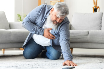 Poster - Mature man with heart attack trying to call an ambulance