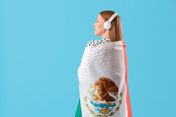 Poster - Young woman in headphones with Mexican flag on blue background, back view