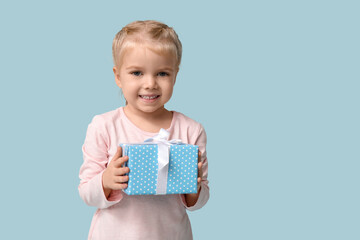 Sticker - Cute happy little girl with gift box on blue background. Hanukkah celebration