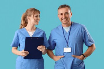 Poster - Mature doctor with his assistant on blue background