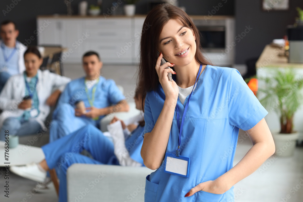 Female doctor talking by mobile phone in hospital