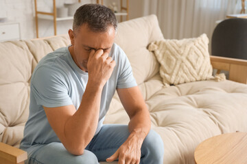Wall Mural - Mature man suffering from migraine at home
