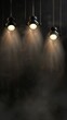 three stage spot lights hanging down on a black background