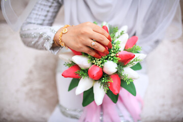 Wall Mural - Close-up of wedding details. The bride's wedding ring on the finger. Malay Wedding day.