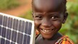 A closeup of a young child smiling as they hold a mini solar panel toy representing the potential for a cleaner greener future. . .