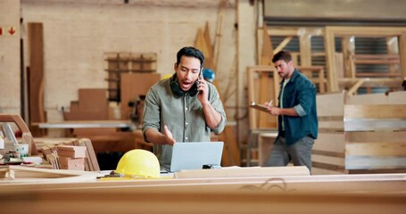 Poster - Asian man or carpenter, phone call and conversation on smartphone for business, upset and angry for project. Male person, cellphone and communication for work with laptop for research in warehouse