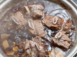 Canvas Print - Beef ribs boiled in a pot	