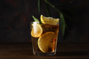 Wall Mural - A glass of cold tea on a dark background