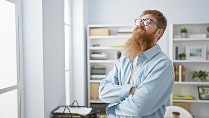 Wall Mural - Confident redhead man smiling, arms crossed, feeling the success, standing relaxed in elegant office interior