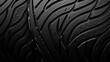 A close up of the texture of a rubber tire tread, with grooves and patterns