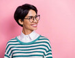 beautiful woman with short hair in striped pullover and glasses look aside copy space isolated on pink color background