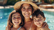 © Keitma - Happy mother and two children family at swimming pool during summer holidays travel