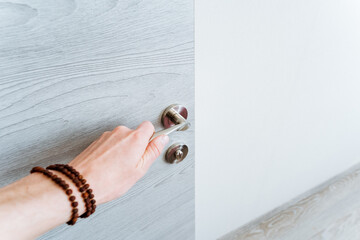 The woman is using her hand to open the door with a gesture