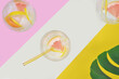 Drinks, cocktails with fruits on pink and yellow background, summertime. Top view.
