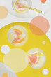 Abstraction in 70's style, collage - photo mixed with graphics, drinks with fruits and ice cubes on yellow background. 