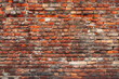 Old red brick wall background, wide panorama of masonry. Red brick laid in rows horizontally.