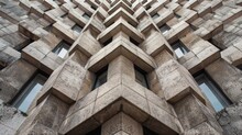 A Pattern Of Neatly Stacked Bricks Forming A Sy Foundation For A Tall Imposing Building In The Cityscape.