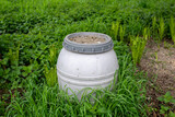 Fototapeta  - Environmental pollution-  a plastic barrel abandoned in a meadow