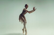 young teenage ballerina poses in a photo studio shows ballet and dance steps