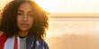 African American Girl Teenager Wrapped in USA Flag on a Beach at Sunset