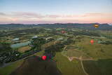 Fototapeta  - Hot Air Balloons in Pokolbin wine region over vineyards and winery, Aerial image, Hunter Valley, NSW, Australia	