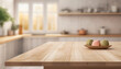 Empty tabletop over defocused kitchen with copy space