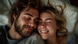 Content white couple snuggling in bed, eyes closed, smiling.