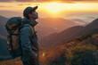 Asian man with backpack watching sunset in mountains, peaceful exploration.
