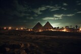 Fototapeta Natura - Nighttime shot with the pyramids illuminated.