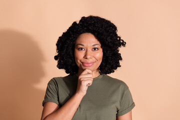 Wall Mural - Photo portrait of pretty young woman touch chin thoughtful dressed trendy khaki outfit isolated on beige color background